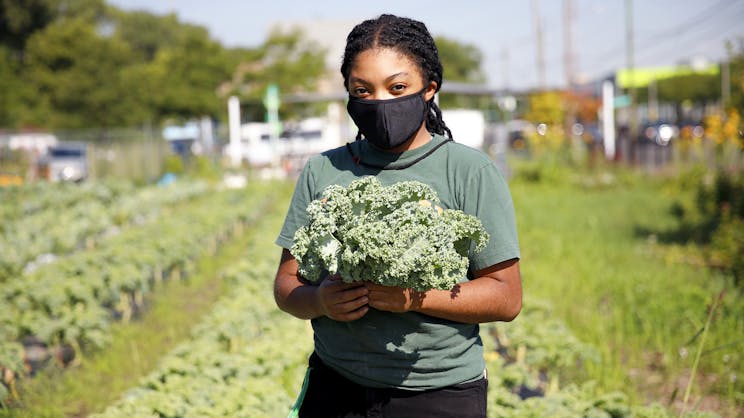 Student holdling produce grown at the Gary Comer Youth Center urban garden.
