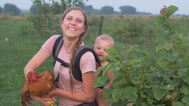 A mother and child on a regenerative agriculture poultry farm in the midwest